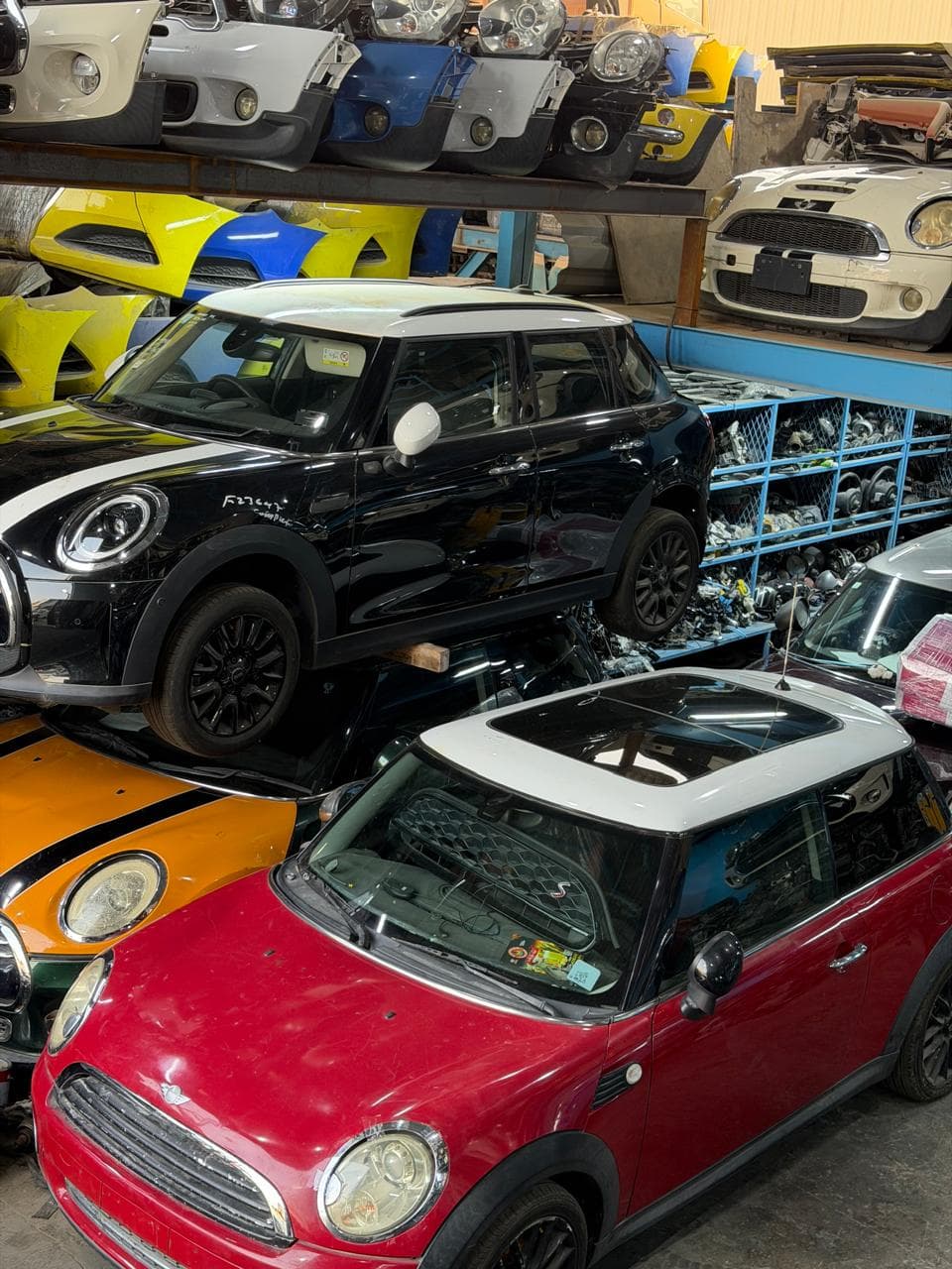 MINI vehicles and body parts stored inside the workshop